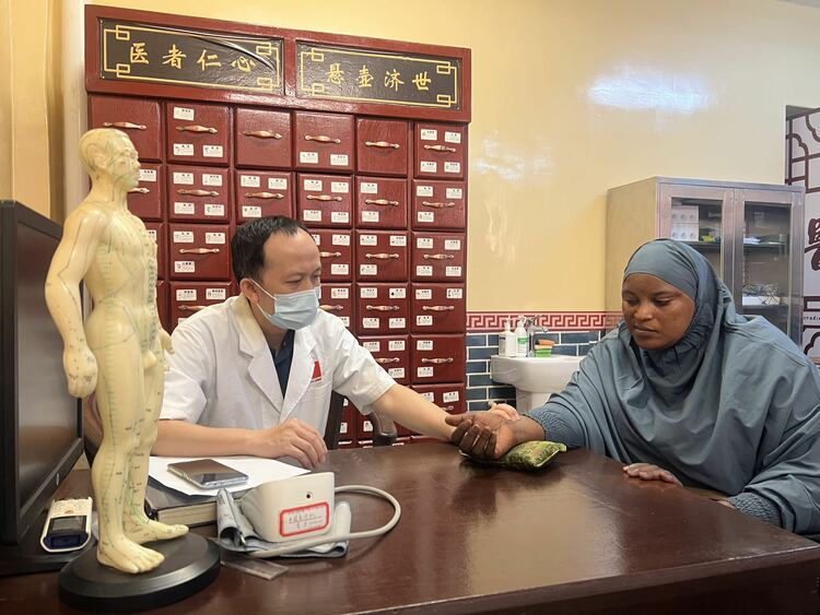中医师为患者把脉问诊进行中医辩证调理